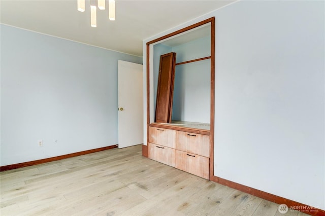 unfurnished bedroom with light wood-type flooring and baseboards