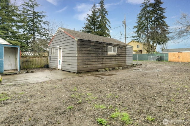 view of shed featuring fence