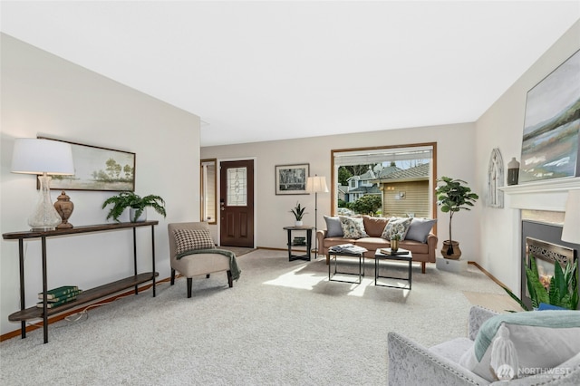 carpeted living area featuring a fireplace and baseboards