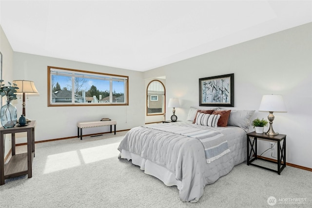 carpeted bedroom featuring baseboards