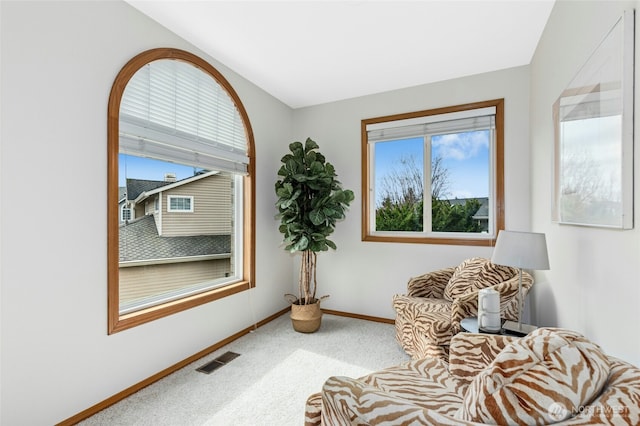 sitting room featuring visible vents, carpet floors, and baseboards