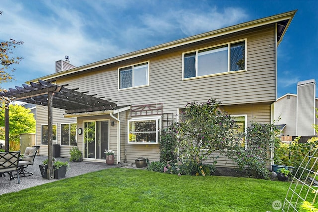 rear view of property featuring fence, a yard, a pergola, a chimney, and a patio area