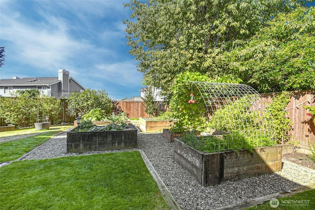 view of yard with a vegetable garden and fence