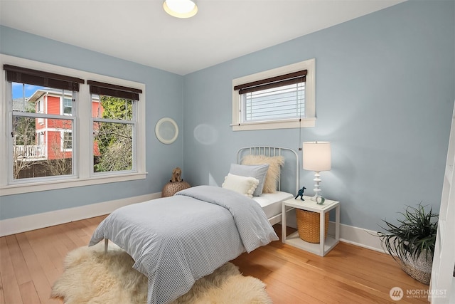 bedroom featuring baseboards and hardwood / wood-style floors