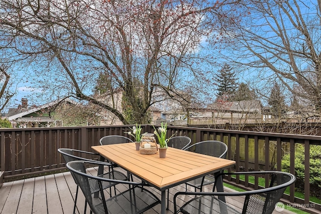 wooden terrace featuring outdoor dining area