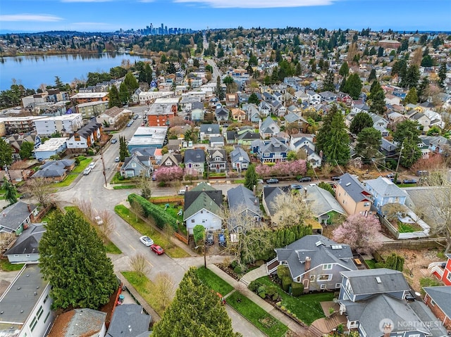 drone / aerial view with a residential view and a water view