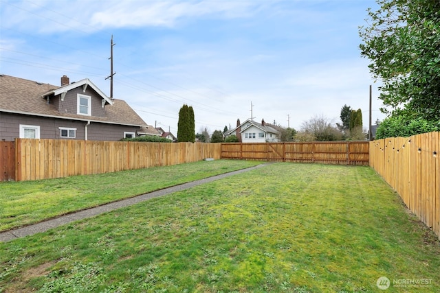 view of yard with a fenced backyard