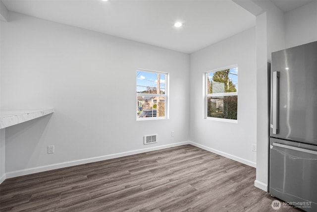 unfurnished dining area featuring visible vents, recessed lighting, baseboards, and dark wood-style flooring