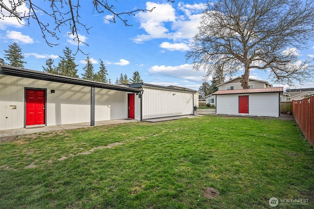 view of yard featuring an outdoor structure and fence