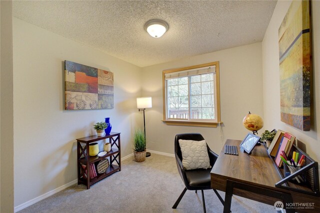 carpeted home office featuring a textured ceiling and baseboards