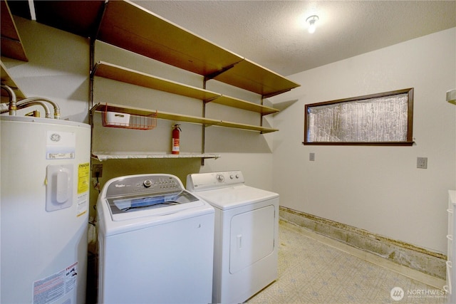 laundry room featuring independent washer and dryer, a textured ceiling, water heater, baseboards, and laundry area