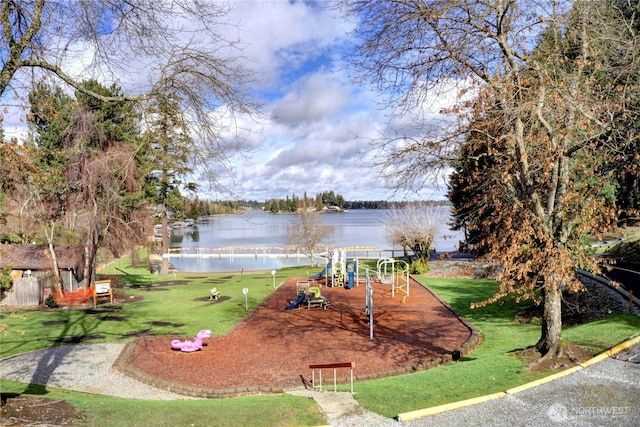 view of community with playground community, a water view, and a lawn