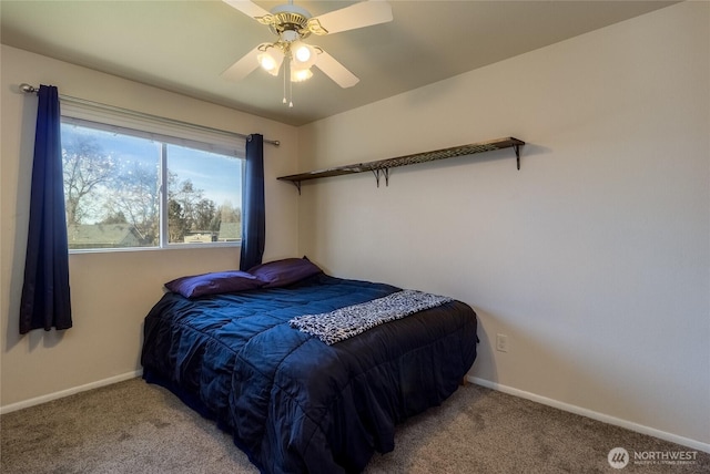 carpeted bedroom with ceiling fan and baseboards