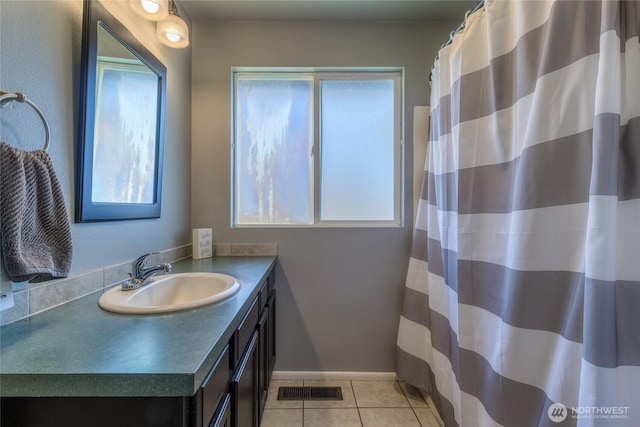 bathroom with vanity, a shower with curtain, visible vents, baseboards, and tile patterned flooring