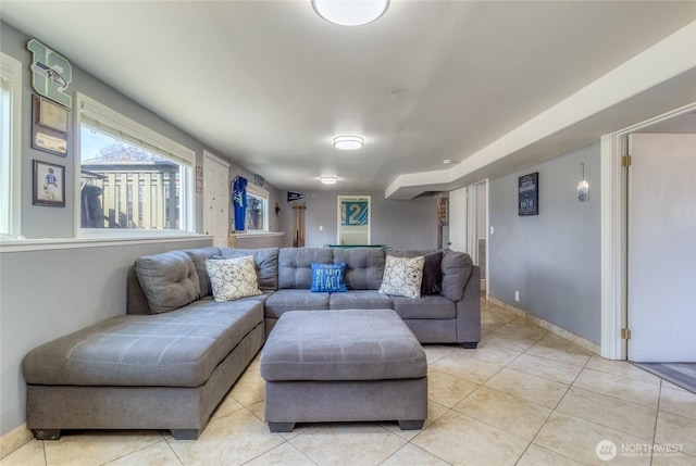 living room with light tile patterned floors and baseboards