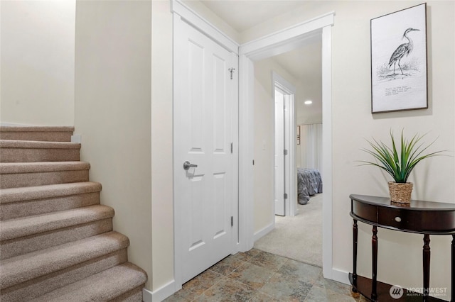 staircase with stone finish floor and baseboards