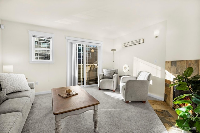 living room featuring carpet flooring and baseboards