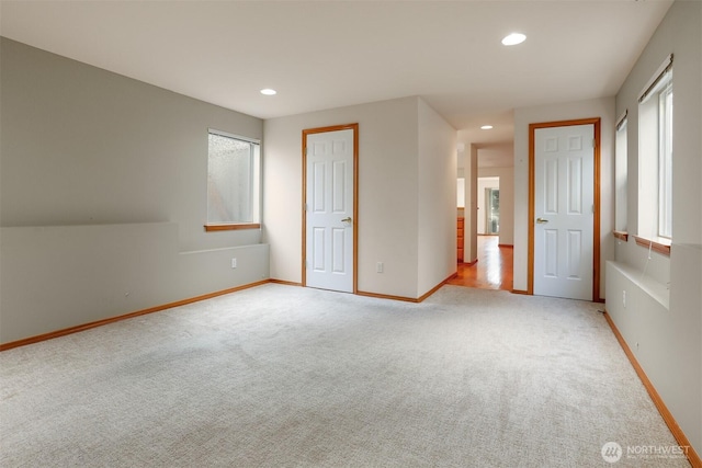 unfurnished bedroom with recessed lighting, light colored carpet, and baseboards