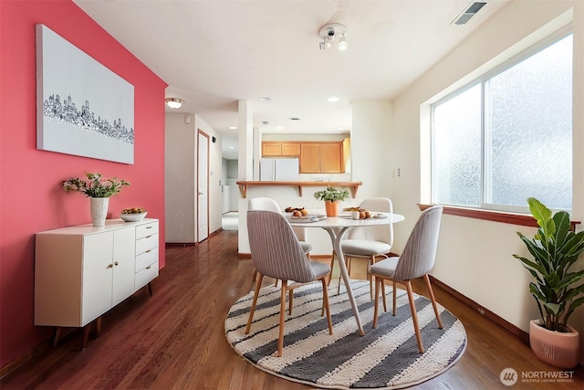 dining room with dark wood-type flooring, recessed lighting, and visible vents