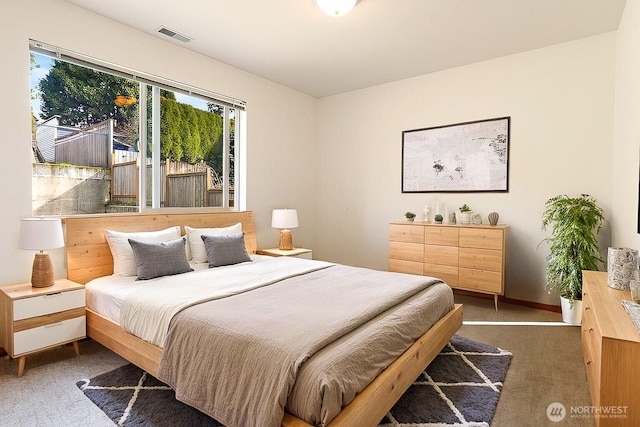 bedroom with visible vents, carpet floors, and baseboards