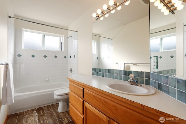 full bathroom featuring toilet, wood finished floors, backsplash, and a healthy amount of sunlight