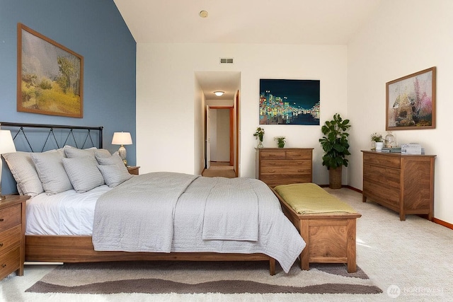 bedroom with light colored carpet, visible vents, and baseboards