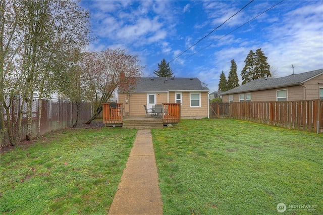 back of property featuring a chimney, a fenced backyard, a lawn, and a wooden deck