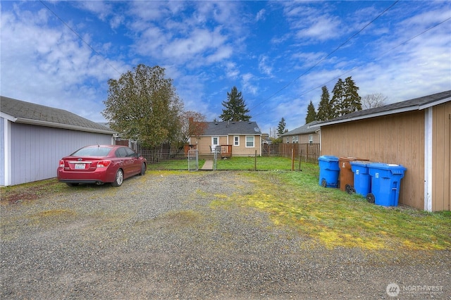 view of front of property with driveway, a front yard, and fence