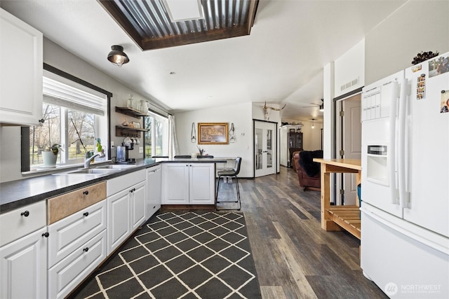 154 Dreamscape Rd, Walla Walla, WA 99362 - kitchen with lofted ceiling, a peninsula, a sink, white fridge with ice dispenser, and dark countertops