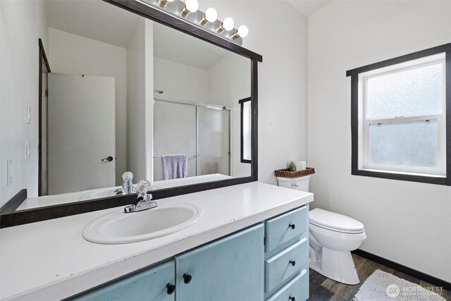154 Dreamscape Rd, Walla Walla, WA 99362 - bathroom featuring toilet, a stall shower, wood finished floors, baseboards, and vanity