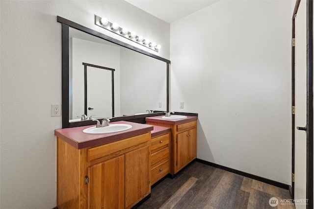 154 Dreamscape Rd, Walla Walla, WA 99362 - bathroom with a sink, baseboards, wood finished floors, and double vanity