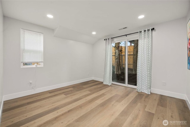 unfurnished room with recessed lighting, wood finished floors, visible vents, and baseboards