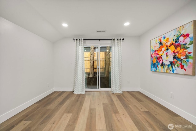 spare room with visible vents, recessed lighting, baseboards, and wood finished floors