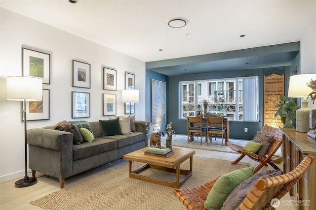 living area with light wood-style flooring and baseboards