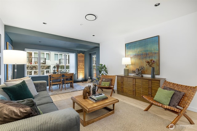 living area featuring light wood finished floors and recessed lighting