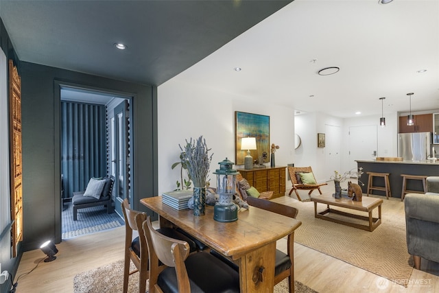 dining area featuring recessed lighting and light wood finished floors