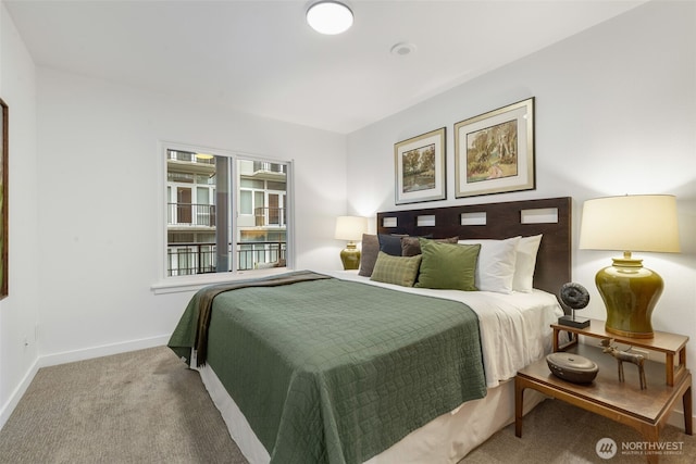 bedroom with baseboards and carpet