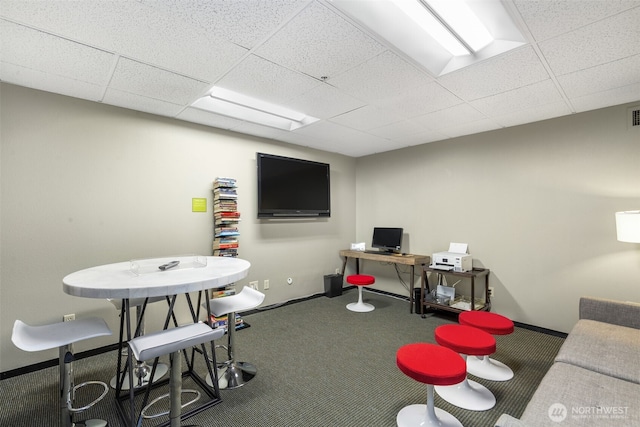 rec room with a drop ceiling, baseboards, and carpet