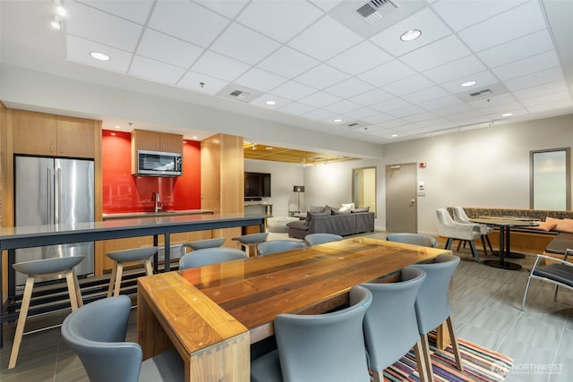 dining area featuring recessed lighting, visible vents, and a drop ceiling