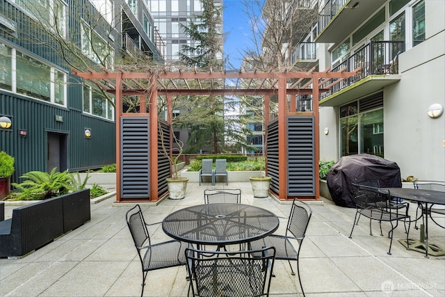 view of patio / terrace with outdoor dining area, a pergola, and grilling area