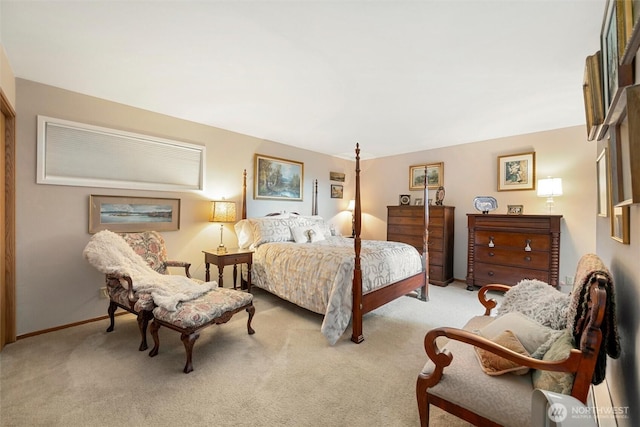 bedroom featuring light carpet and baseboards