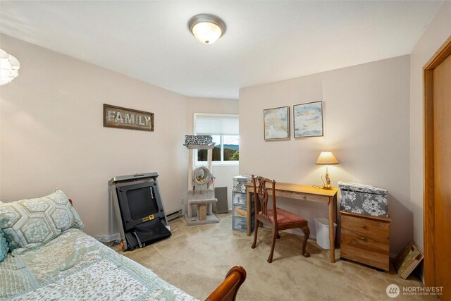 bedroom with light colored carpet and baseboard heating