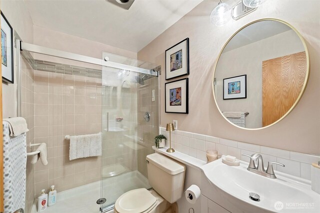 bathroom with vanity, toilet, and a stall shower