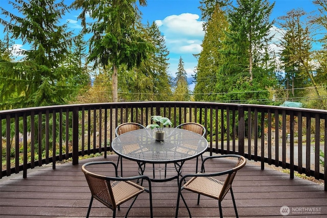 wooden terrace with outdoor dining area