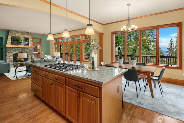 kitchen with light wood finished floors, plenty of natural light, and stainless steel gas cooktop