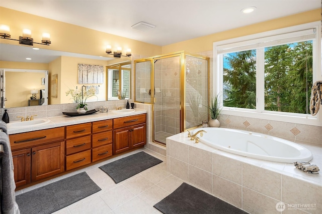 bathroom with a sink, a garden tub, double vanity, and a shower stall