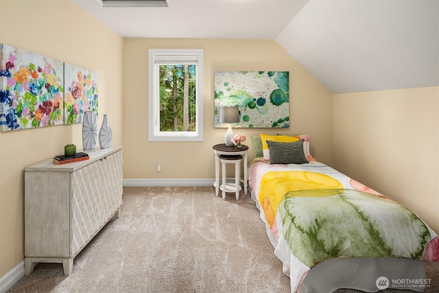 carpeted bedroom with baseboards and vaulted ceiling