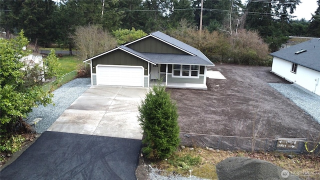 view of front facade featuring board and batten siding, concrete driveway, and an attached garage