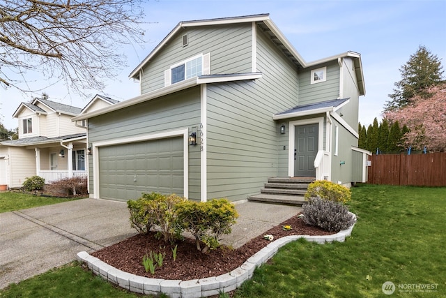 traditional-style house featuring a garage, concrete driveway, a front yard, and fence