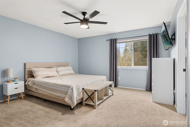 carpeted bedroom featuring ceiling fan and baseboards